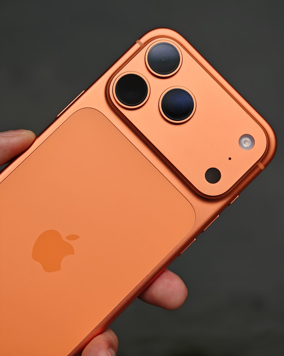 Orange iPhone with triple camera system